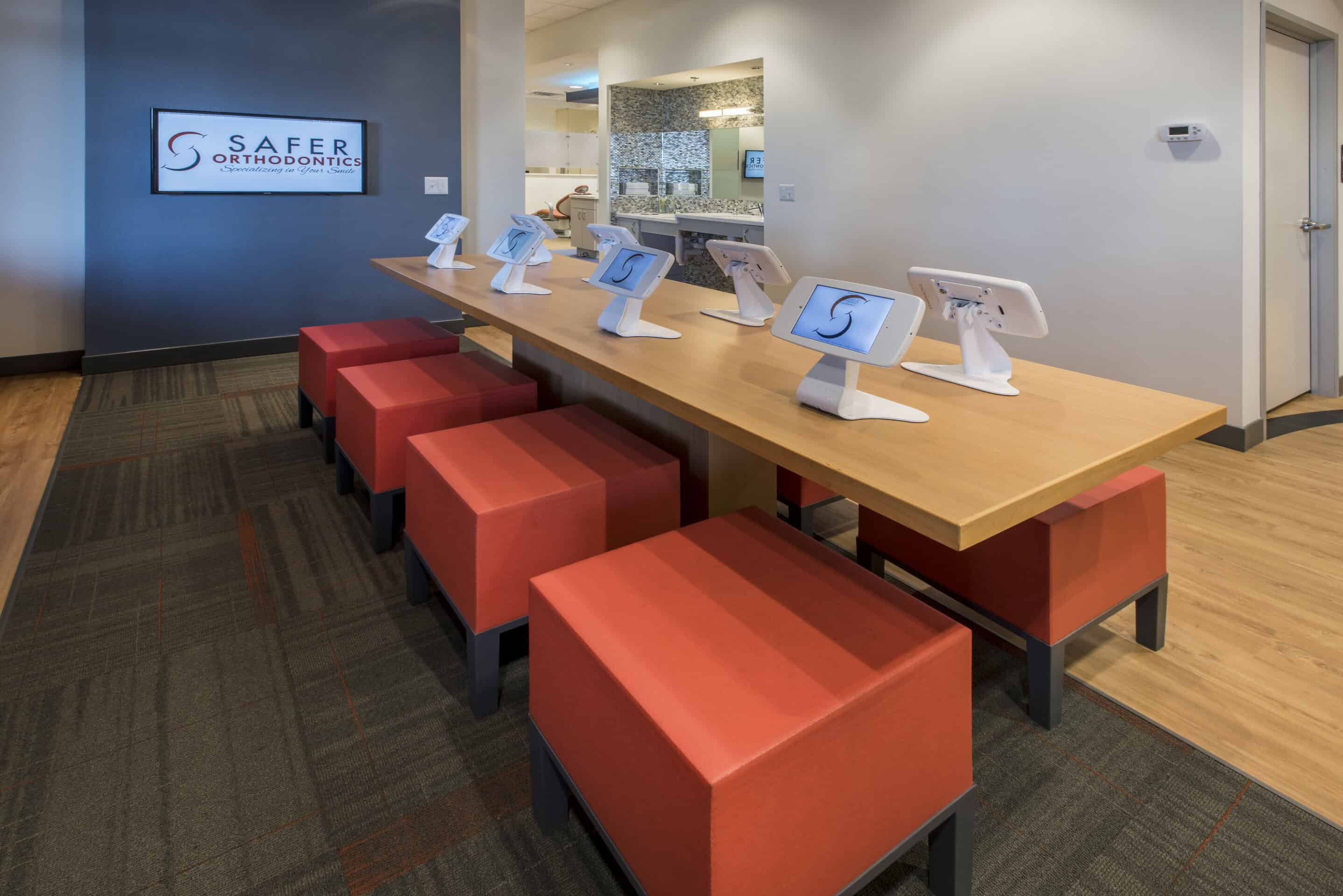 Orthodontic office lobby with digital kiosks.