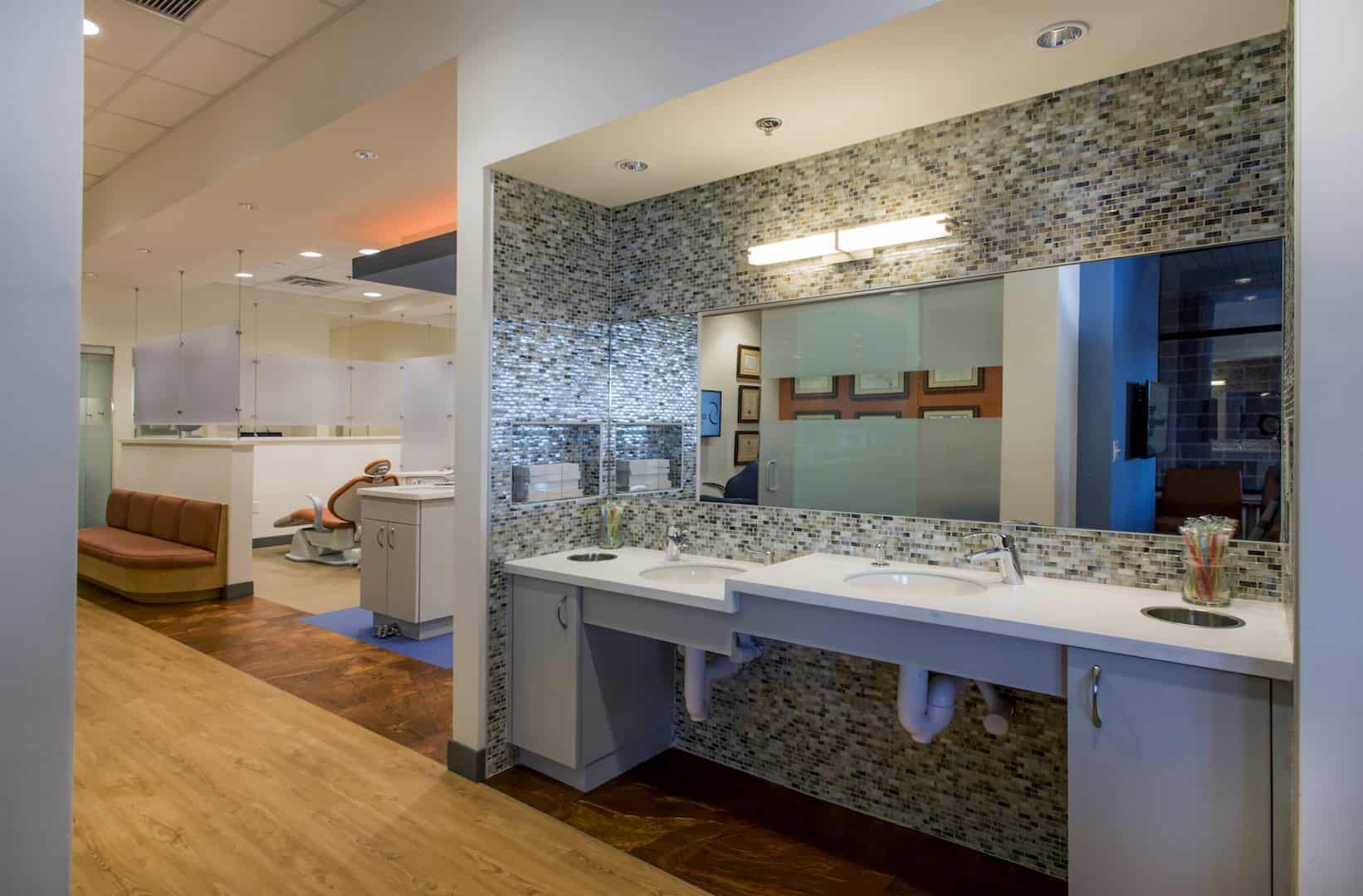 Modern dental office with sinks and chairs.