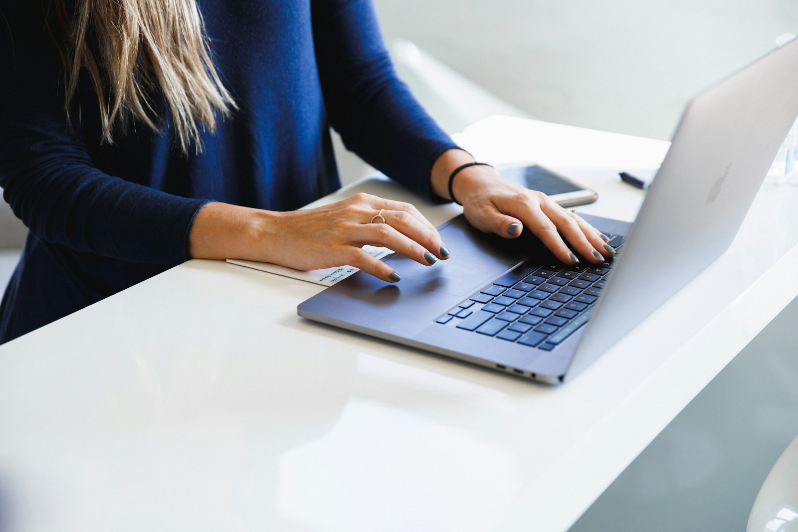 Person completing a form on a laptop.